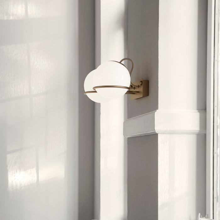 Wall-mounted lamp with a white shade next to a window.